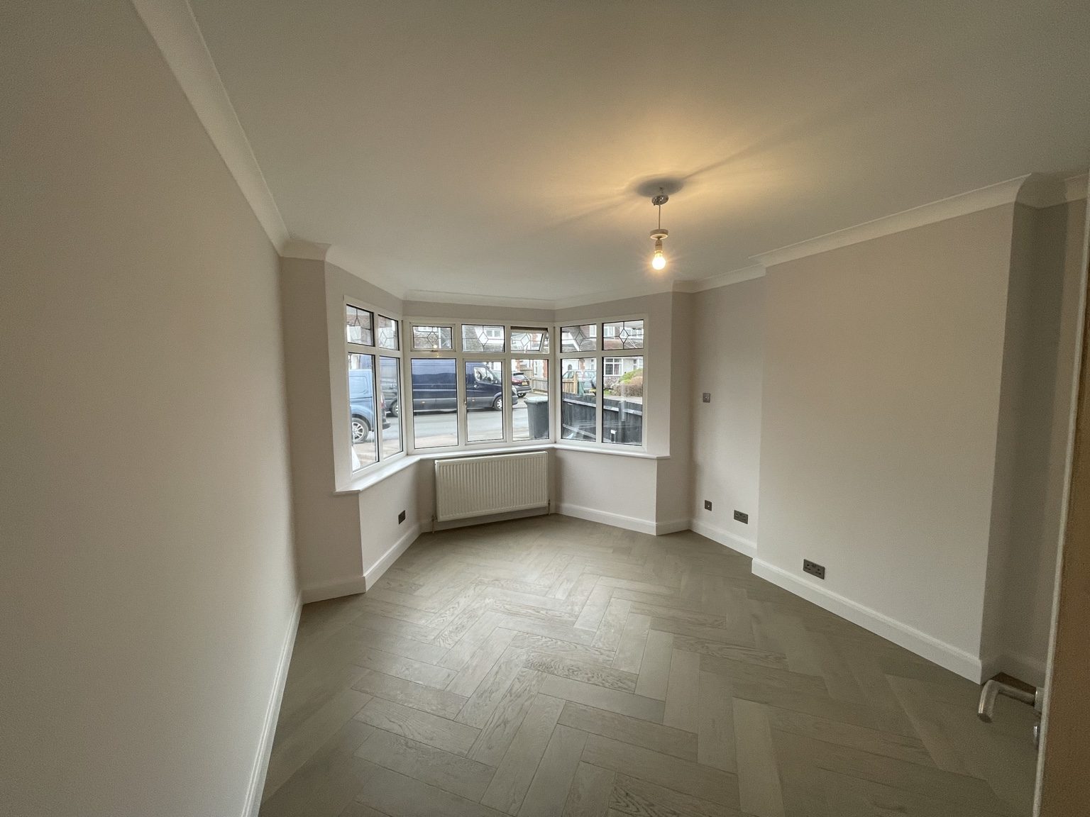 Bright renovated room with bay window and oak flooring