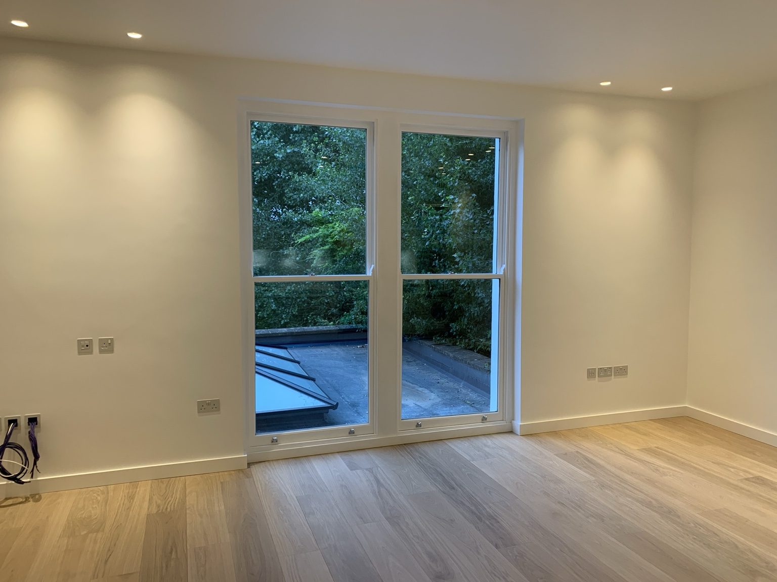 New loft room with glazed doors and rooflight